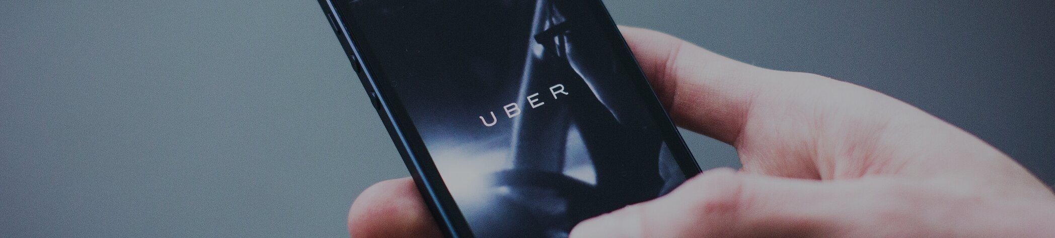 Person using mobile rideshare app for Uber car hire