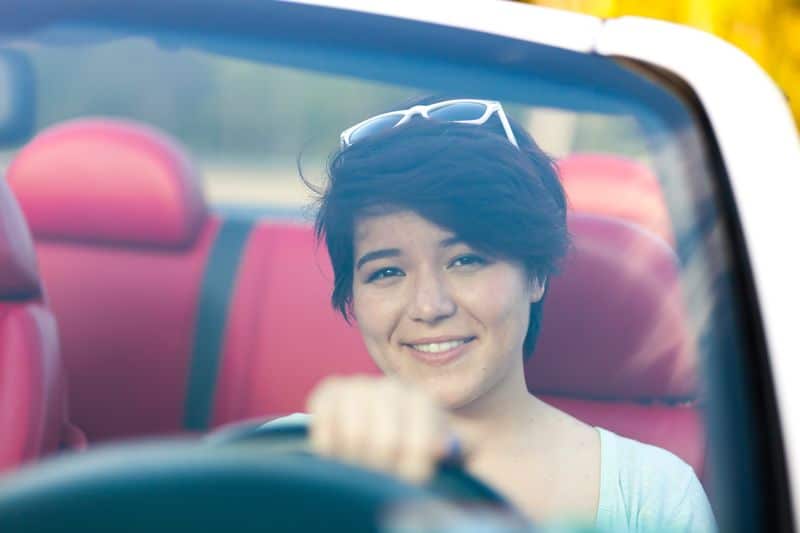 woman driving her vehicle after a successful Beaconsfield long-term car hire
